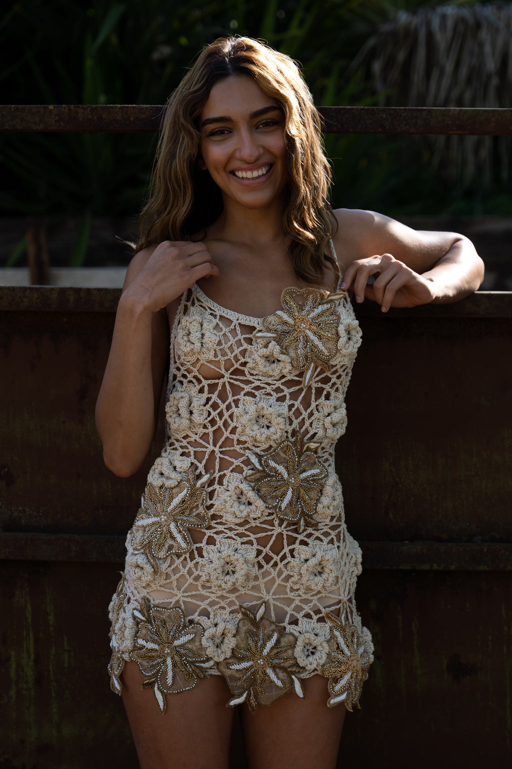 La Sirenita hand-crocheted cream mini dress with hand-embroidered patches and adjustable straps
