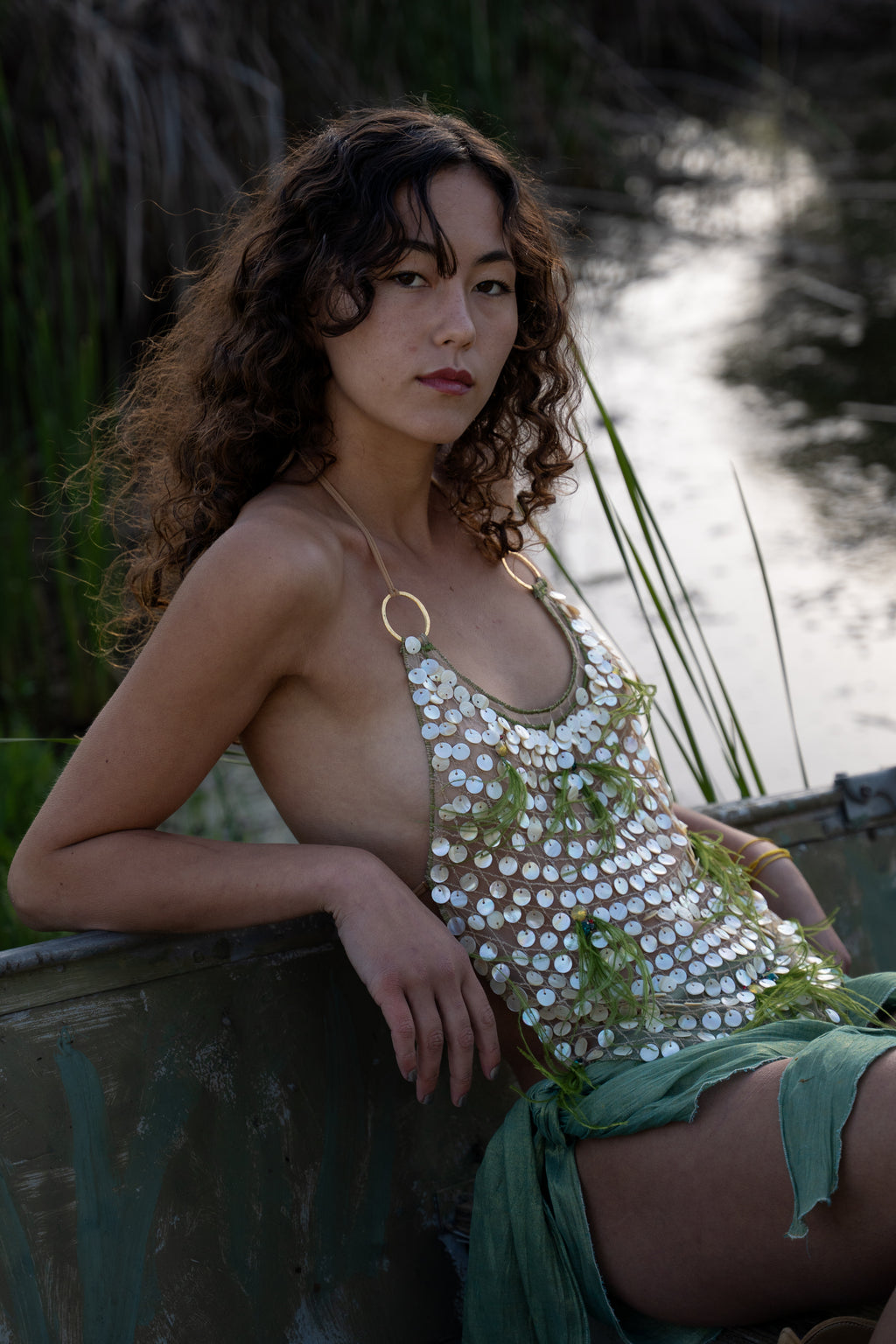 Aura handmade halter top with natural abalone seashell embellishments, sheer nude tulle, light olive ostrich feathers and red and green crystal accents
